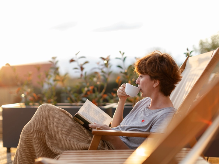 A woman reading and drinking tea