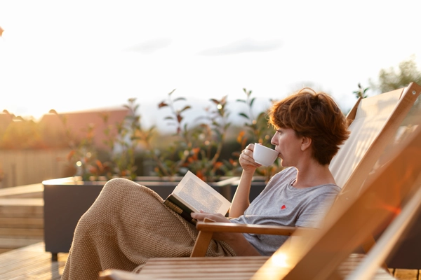 A woman reading and drinking tea