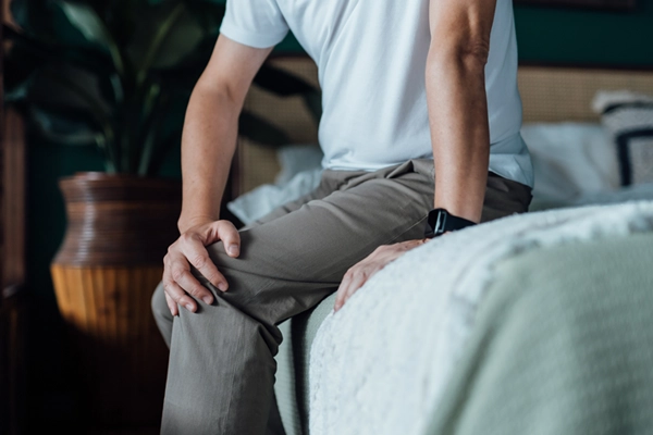 Person holding knee in pain