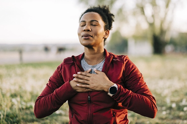 A woman taking a deep breath