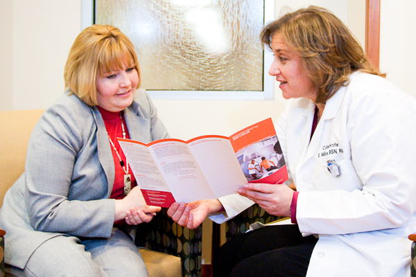 Patient looking at brochure.