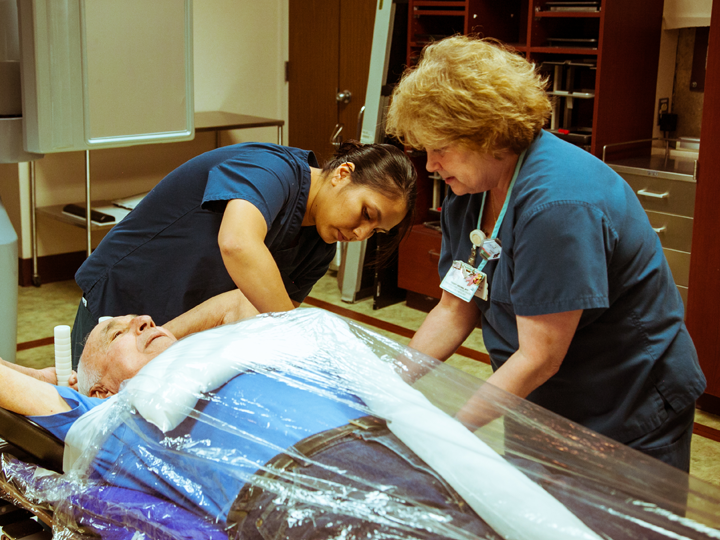 Nurses helping a patient
