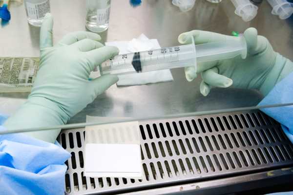 Hands holding a syringe