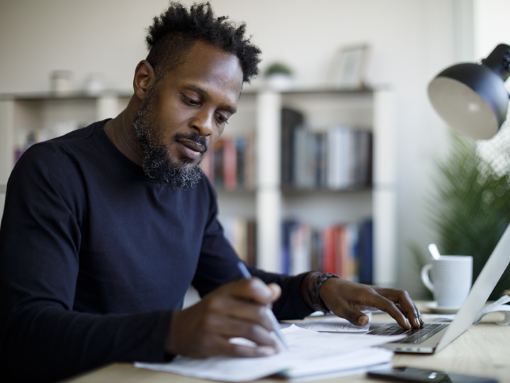 Man with a pen and computer