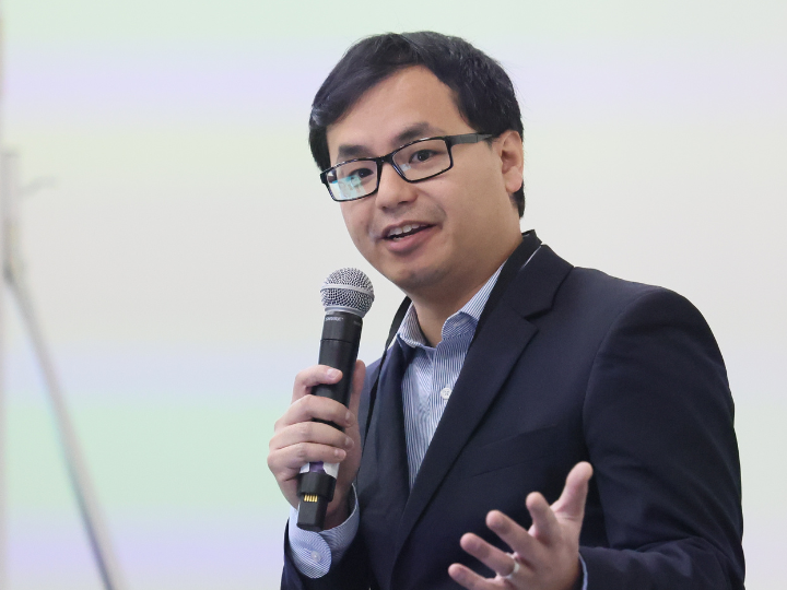 Speaker speaking into microphone