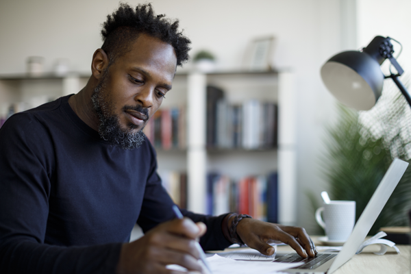 Man with a pen and computer