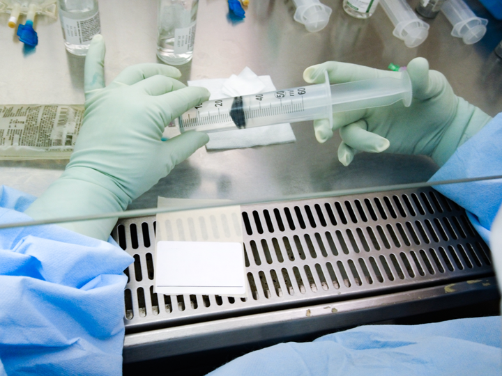 Hands holding a syringe